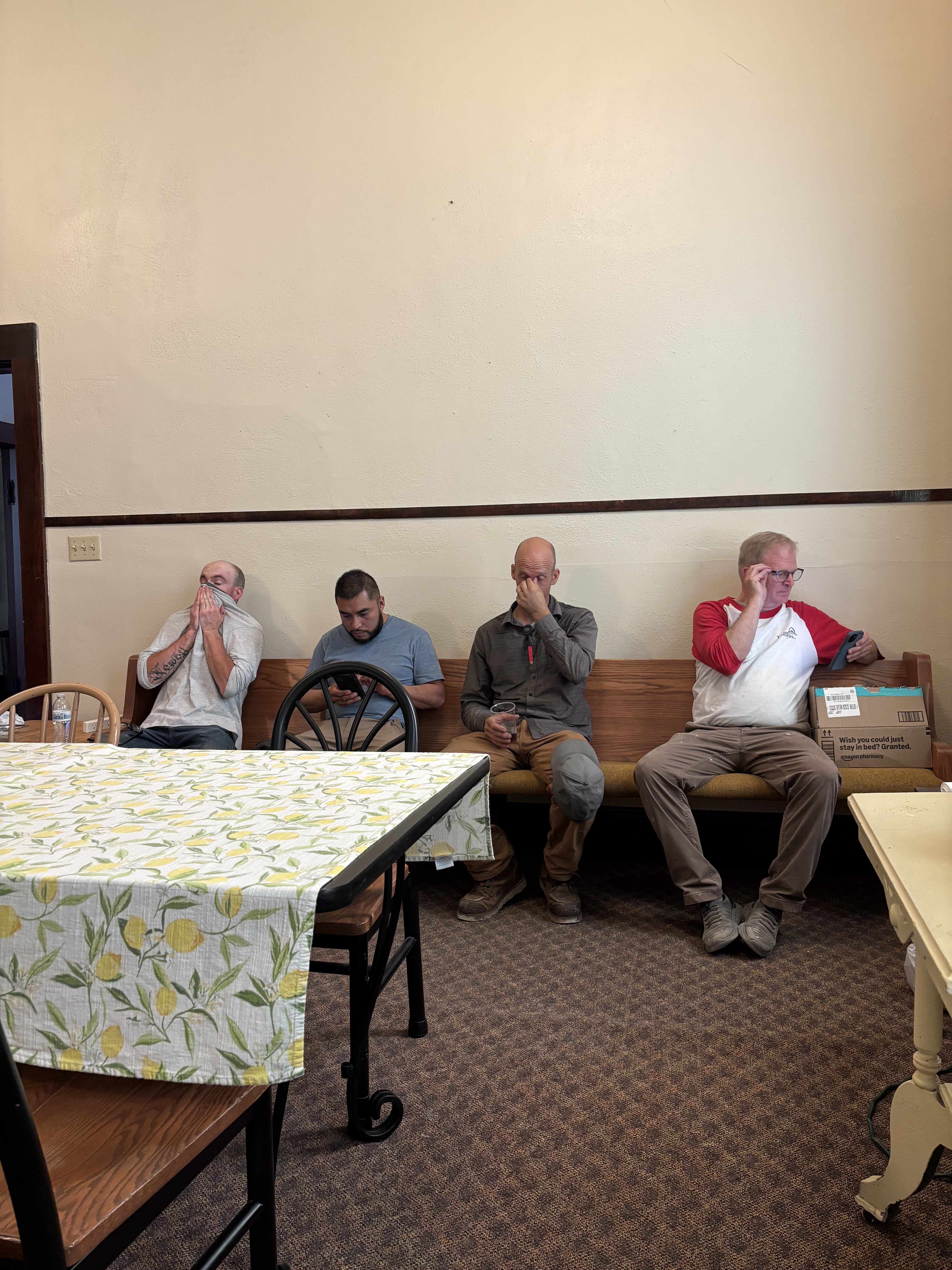 Men taking a break on bench in candid fellowship moment at Wisconsin men's event