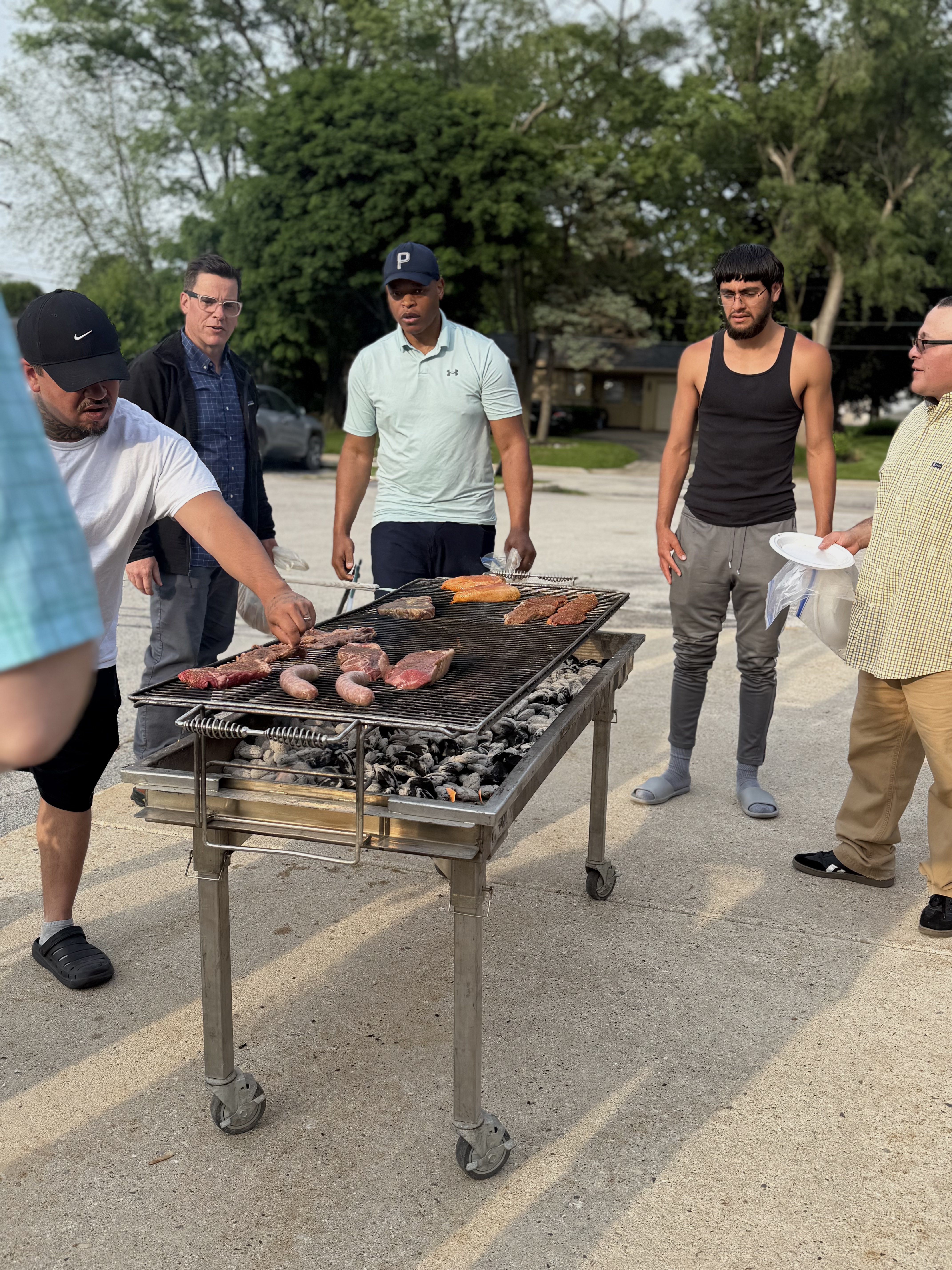 Group of men grilling outdoors at Wisconsin Men's Ministry fellowship cookout