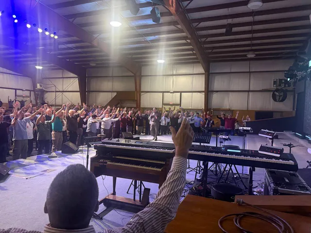 Wide worship view from behind the organ and keyboards.