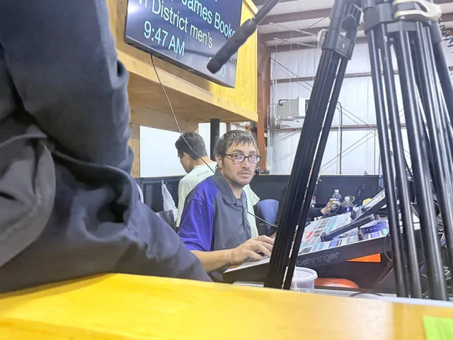 Audio operator working at a Behringer mixing console behind the congregation.