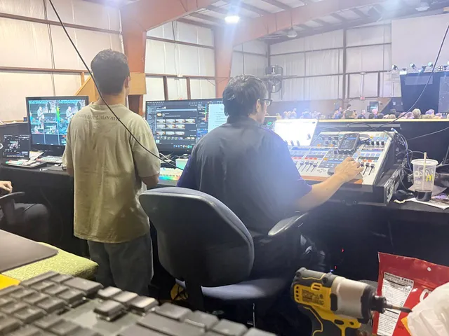 Audio and video team monitoring multiple screens and the live service.